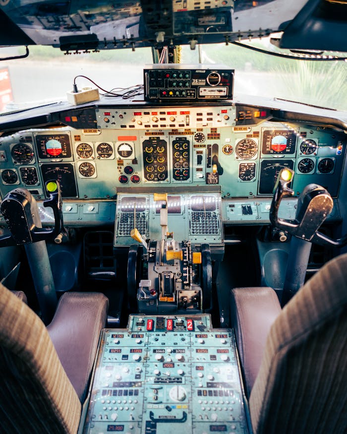 Close-up view of an airplane cockpit showcasing various control panels and instruments.